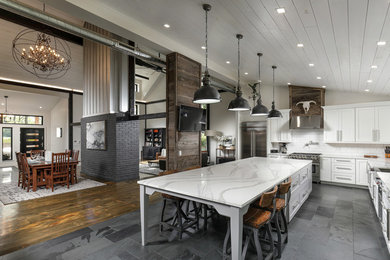 Open concept kitchen - large rustic l-shaped porcelain tile and gray floor open concept kitchen idea in Other with white cabinets, quartz countertops, white backsplash, subway tile backsplash, stainless steel appliances, an island, white countertops and shaker cabinets