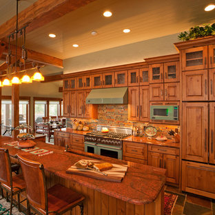 Photo of a large country l-shaped separate kitchen in Denver with coloured appliances, an undermount sink, raised-panel cabinets, medium wood cabinets, granite benchtops, multi-coloured splashback, slate splashback, slate floors, with island and multi-coloured floor.