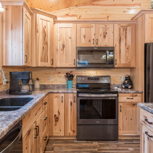 Photo of a mid-sized country l-shaped eat-in kitchen in Minneapolis with an undermount sink, shaker cabinets, medium wood cabinets, laminate benchtops, stainless steel appliances, linoleum floors, with island, multi-coloured floor and turquoise benchtop.