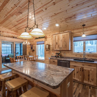 Design ideas for a mid-sized country l-shaped eat-in kitchen in Minneapolis with an undermount sink, shaker cabinets, medium wood cabinets, laminate benchtops, stainless steel appliances, linoleum floors, with island, multi-coloured floor and turquoise benchtop.