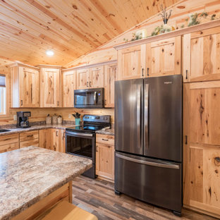 Photo of a mid-sized country l-shaped eat-in kitchen in Minneapolis with an undermount sink, shaker cabinets, medium wood cabinets, laminate benchtops, stainless steel appliances, linoleum floors, with island, multi-coloured floor and turquoise benchtop.