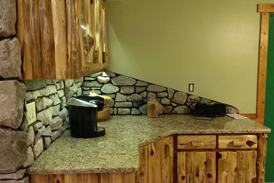 Large mountain style u-shaped ceramic tile eat-in kitchen photo in Other with a double-bowl sink, shaker cabinets, distressed cabinets, granite countertops, gray backsplash, stone slab backsplash, stainless steel appliances and an island