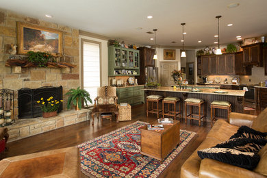 Example of a mid-sized mountain style u-shaped brown floor and dark wood floor eat-in kitchen design in Austin with a farmhouse sink, beaded inset cabinets, medium tone wood cabinets, granite countertops, beige backsplash, ceramic backsplash, stainless steel appliances, two islands and multicolored countertops