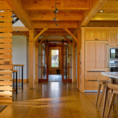 Mountain style eat-in kitchen photo in Burlington with shaker cabinets, light wood cabinets and paneled appliances