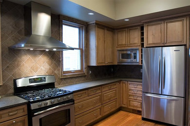 Enclosed kitchen - mid-sized rustic u-shaped medium tone wood floor and brown floor enclosed kitchen idea in Philadelphia with a double-bowl sink, granite countertops, brown backsplash, ceramic backsplash, stainless steel appliances and no island