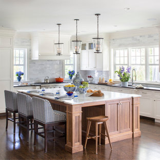 Open concept kitchen - large transitional l-shaped medium tone wood floor open concept kitchen idea in New York with an undermount sink, shaker cabinets, white cabinets, marble countertops, gray backsplash, an island, stainless steel appliances and marble backsplash