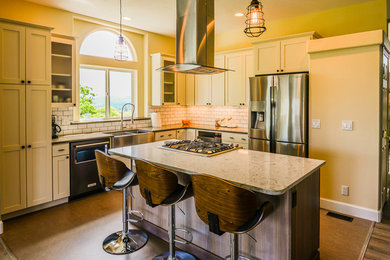 Mid-sized trendy l-shaped vinyl floor and brown floor open concept kitchen photo in Portland with a farmhouse sink, shaker cabinets, white cabinets, white backsplash, subway tile backsplash, stainless steel appliances and an island