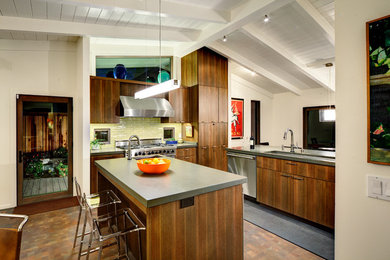 Inspiration for a mid-sized contemporary l-shaped brown floor kitchen remodel in San Francisco with an undermount sink, flat-panel cabinets, medium tone wood cabinets, zinc countertops, stainless steel appliances, an island and yellow backsplash