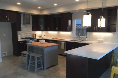 Exempel på ett mellanstort modernt u-kök, med en dubbel diskho, släta luckor, skåp i mörkt trä, bänkskiva i kvartsit, vitt stänkskydd, stänkskydd i glaskakel, rostfria vitvaror, betonggolv, en köksö och grått golv