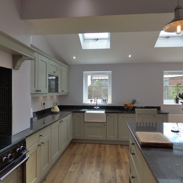 sage green painted shaker in large open plan kitchen