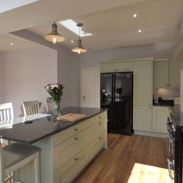 sage green painted shaker in large open plan kitchen