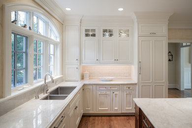 Kitchen - traditional kitchen idea in Philadelphia with a drop-in sink, quartzite countertops and an island