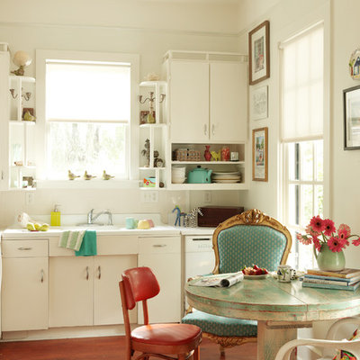Inspiration for a shabby-chic style single-wall medium tone wood floor eat-in kitchen remodel in Burlington with flat-panel cabinets and white cabinets