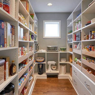 Kitchen pantry - large modern u-shaped medium tone wood floor kitchen pantry idea in Seattle with flat-panel cabinets, white cabinets, stainless steel appliances and no island