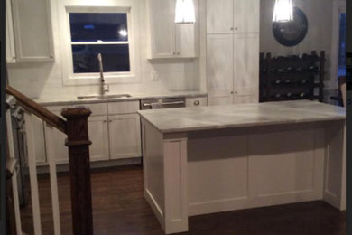 Transitional kitchen photo in Chicago with shaker cabinets, white cabinets, marble countertops and an island