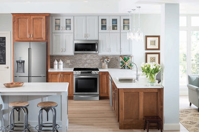 Inspiration for a mid-sized rustic l-shaped light wood floor open concept kitchen remodel in Vancouver with a double-bowl sink, beaded inset cabinets, gray cabinets, multicolored backsplash, matchstick tile backsplash, stainless steel appliances and an island
