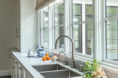 Large trendy l-shaped dark wood floor kitchen photo in San Francisco with shaker cabinets, an island, white cabinets, an undermount sink, gray backsplash, subway tile backsplash, stainless steel appliances and gray countertops