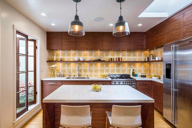 Inspiration for a modern kitchen remodel in San Francisco with a single-bowl sink, flat-panel cabinets, quartz countertops, yellow backsplash, cement tile backsplash, stainless steel appliances and an island
