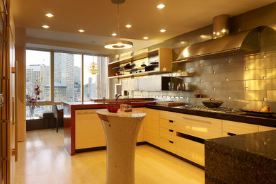 Example of a mid-sized trendy u-shaped bamboo floor eat-in kitchen design in San Francisco with an undermount sink, flat-panel cabinets, light wood cabinets, concrete countertops, gray backsplash, ceramic backsplash and stainless steel appliances