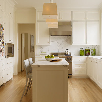 Elegant kitchen photo in San Francisco with stainless steel appliances and marble backsplash