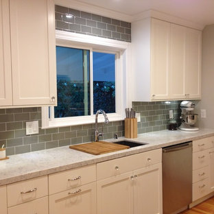 Transitional eat-in kitchen ideas - Example of a transitional l-shaped eat-in kitchen design in San Francisco with an undermount sink, shaker cabinets, white cabinets, quartz countertops, green backsplash, porcelain backsplash and stainless steel appliances