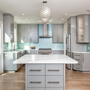 Mid-sized contemporary kitchen appliance - Inspiration for a mid-sized contemporary u-shaped medium tone wood floor and brown floor kitchen remodel in San Francisco with an undermount sink, flat-panel cabinets, gray cabinets, blue backsplash, stainless steel appliances, an island, quartzite countertops and glass tile backsplash
