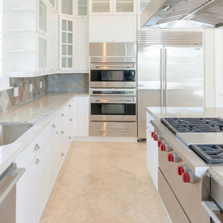 Design ideas for a large beach style u-shaped eat-in kitchen in Other with a drop-in sink, shaker cabinets, white cabinets, granite benchtops, multi-coloured splashback, slate splashback, stainless steel appliances, travertine floors, multiple islands, beige floor and multi-coloured benchtop.