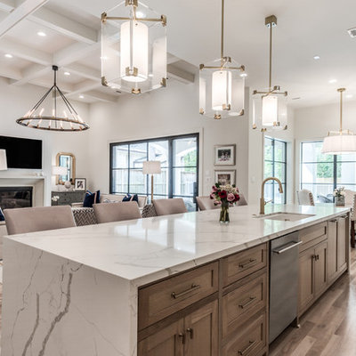 Huge transitional light wood floor and beige floor open concept kitchen photo in Houston with an undermount sink, shaker cabinets, quartz countertops, stainless steel appliances, an island, white countertops and medium tone wood cabinets