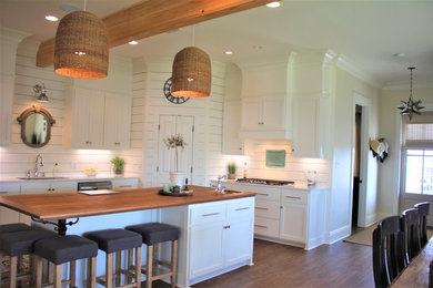 Eat-in kitchen - mid-sized craftsman l-shaped eat-in kitchen idea in New Orleans with flat-panel cabinets, white cabinets and an island