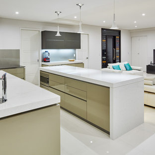 Inspiration for a large contemporary l-shaped open plan kitchen in Sydney with a double-bowl sink, flat-panel cabinets, granite benchtops, glass sheet splashback, white appliances, porcelain floors, multiple islands and white floor.