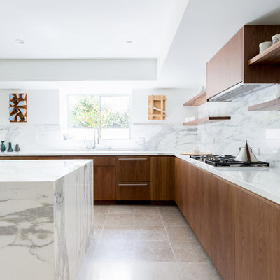 Example of a large trendy l-shaped ceramic tile and gray floor kitchen design in Los Angeles with an island, flat-panel cabinets, marble backsplash, an undermount sink, brown cabinets, marble countertops, white backsplash, paneled appliances and gray countertops