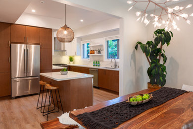 Eat-in kitchen - mid-sized contemporary u-shaped light wood floor and beige floor eat-in kitchen idea in Los Angeles with an undermount sink, flat-panel cabinets, medium tone wood cabinets, quartz countertops, white backsplash, stone slab backsplash, stainless steel appliances, an island and white countertops