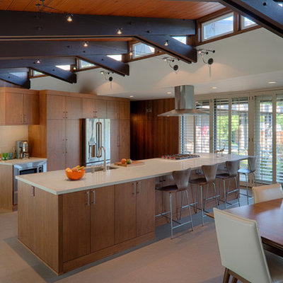 Large mid-century modern single-wall vinyl floor and beige floor eat-in kitchen photo in San Francisco with an undermount sink, flat-panel cabinets, medium tone wood cabinets, quartz countertops, an island and stainless steel appliances