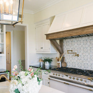 Large rustic open concept kitchen remodeling - Large mountain style u-shaped terra-cotta tile and brown floor open concept kitchen photo in Santa Barbara with an undermount sink, beaded inset cabinets, white cabinets, quartz countertops, white backsplash, subway tile backsplash, stainless steel appliances, an island and black countertops