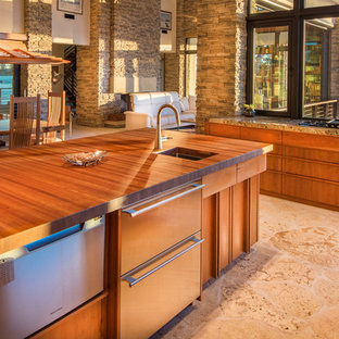 This is an example of a large midcentury l-shaped open plan kitchen in Tampa with an undermount sink, flat-panel cabinets, medium wood cabinets, wood benchtops, panelled appliances, limestone floors and with island.