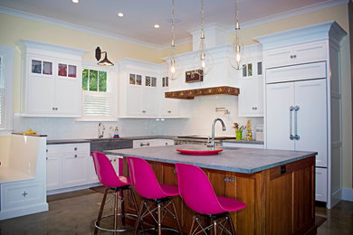 Mid-sized eclectic l-shaped concrete floor open concept kitchen photo in Tampa with a farmhouse sink, shaker cabinets, white cabinets, soapstone countertops, white backsplash, subway tile backsplash, stainless steel appliances and an island