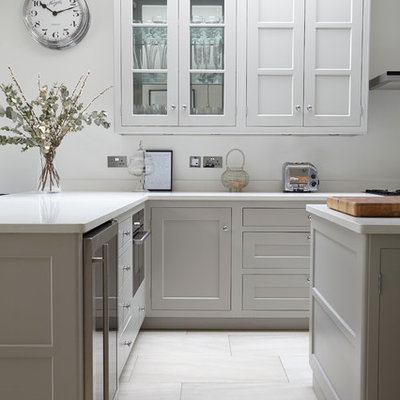 Kitchen - transitional kitchen idea in London with shaker cabinets, white cabinets and an island