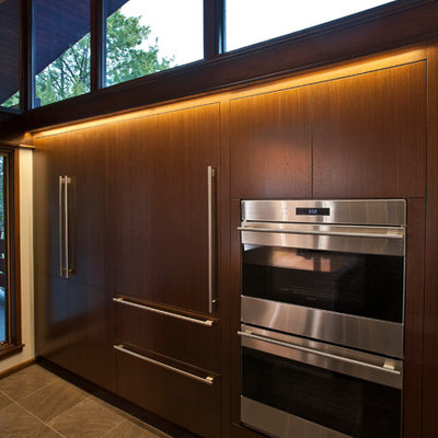 Eat-in kitchen - large 1950s galley porcelain tile eat-in kitchen idea in Cincinnati with a single-bowl sink, flat-panel cabinets, medium tone wood cabinets, quartz countertops, stainless steel appliances and an island
