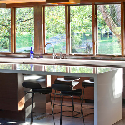 Large 1960s galley porcelain tile eat-in kitchen photo in Cincinnati with a single-bowl sink, flat-panel cabinets, medium tone wood cabinets, quartz countertops, stainless steel appliances and an island
