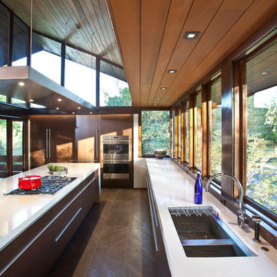 Inspiration for a large mid-century modern galley porcelain tile eat-in kitchen remodel in Cincinnati with a single-bowl sink, flat-panel cabinets, medium tone wood cabinets, quartz countertops, stainless steel appliances and an island