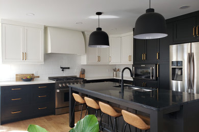 Eat-in kitchen - mid-sized scandinavian l-shaped light wood floor and brown floor eat-in kitchen idea in Edmonton with an undermount sink, shaker cabinets, soapstone countertops, white backsplash, subway tile backsplash, stainless steel appliances, an island and black countertops