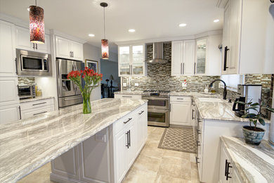 Example of a mid-sized classic galley beige floor kitchen design in Chicago with a double-bowl sink, raised-panel cabinets, white cabinets, multicolored backsplash, stainless steel appliances, an island and matchstick tile backsplash