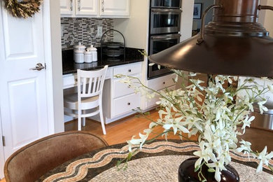 Open concept kitchen - mid-sized l-shaped light wood floor and brown floor open concept kitchen idea in Richmond with an undermount sink, raised-panel cabinets, white cabinets, quartz countertops, multicolored backsplash, ceramic backsplash, stainless steel appliances, an island and black countertops