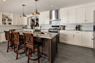 Inspiration for a large transitional u-shaped porcelain tile and gray floor open concept kitchen remodel in Toronto with white cabinets, granite countertops, white backsplash, subway tile backsplash, stainless steel appliances, an island, an undermount sink and shaker cabinets