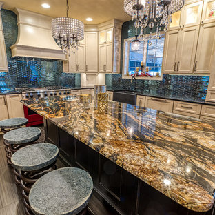 Large eclectic l-shaped separate kitchen in Philadelphia with a farmhouse sink, recessed-panel cabinets, white cabinets, granite benchtops, blue splashback, glass tile splashback, coloured appliances, porcelain floors, with island, black floor and black benchtop.
