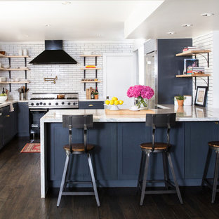 Small transitional kitchen designs - Example of a small transitional u-shaped dark wood floor and brown floor kitchen design in Las Vegas with an undermount sink, shaker cabinets, gray cabinets, quartzite countertops, white backsplash, subway tile backsplash, stainless steel appliances and a peninsula