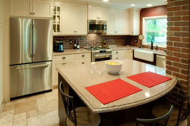 Example of a small classic l-shaped travertine floor eat-in kitchen design in Newark with a farmhouse sink, shaker cabinets, quartz countertops, red backsplash, stainless steel appliances and an island