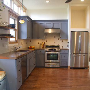 Eclectic kitchen ideas - Example of an eclectic l-shaped kitchen design in Portland with stainless steel appliances, a single-bowl sink and blue cabinets