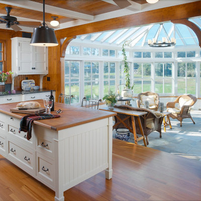 Example of a classic kitchen design in Providence with wood countertops