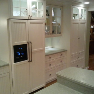 Large coastal eat-in kitchen pictures - Eat-in kitchen - large coastal u-shaped light wood floor eat-in kitchen idea in Other with an integrated sink, flat-panel cabinets, white cabinets, solid surface countertops, white backsplash, ceramic backsplash, stainless steel appliances and a peninsula